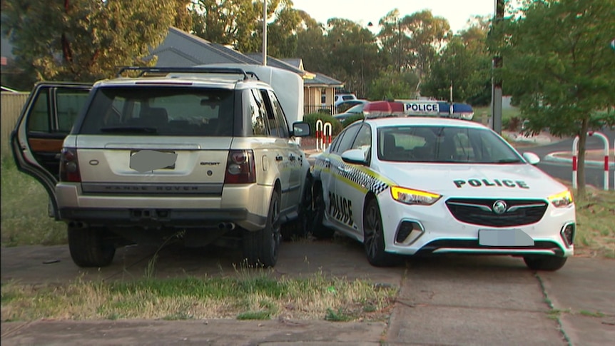 The front of a bronze coloured Range Rover crashed into a police car