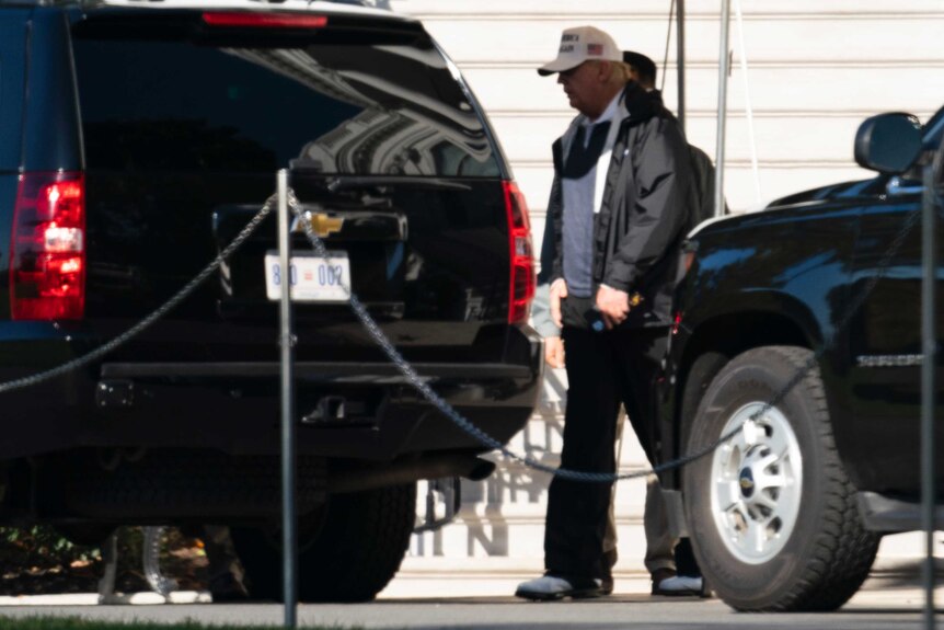 Donald Trump walks to a car outside the White House.