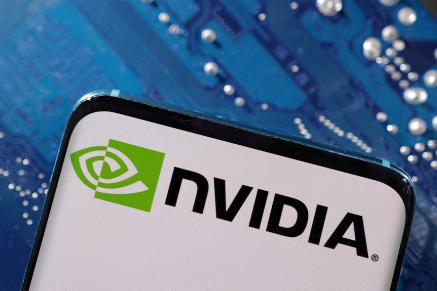 Nvidia logo displayed on a mobile phone screen with a circuit board in the background.