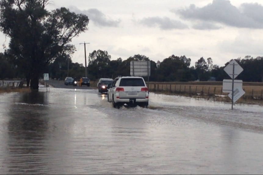 Cars driving through floodwaters