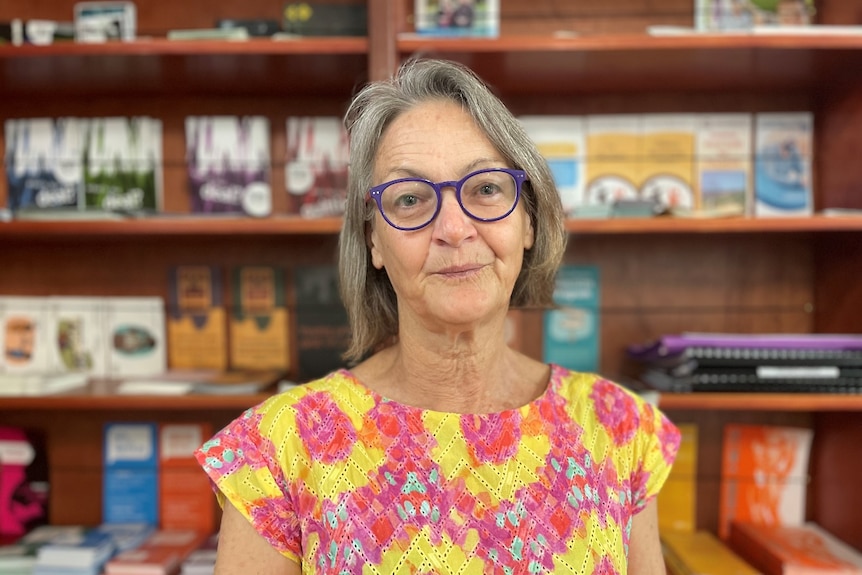 woman wearing glasses smiling at camera 