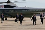 US Secret Service agents walk towards US President Barack Obama as he prepares to depart Andrews Air Force Base, October 28, 2014
