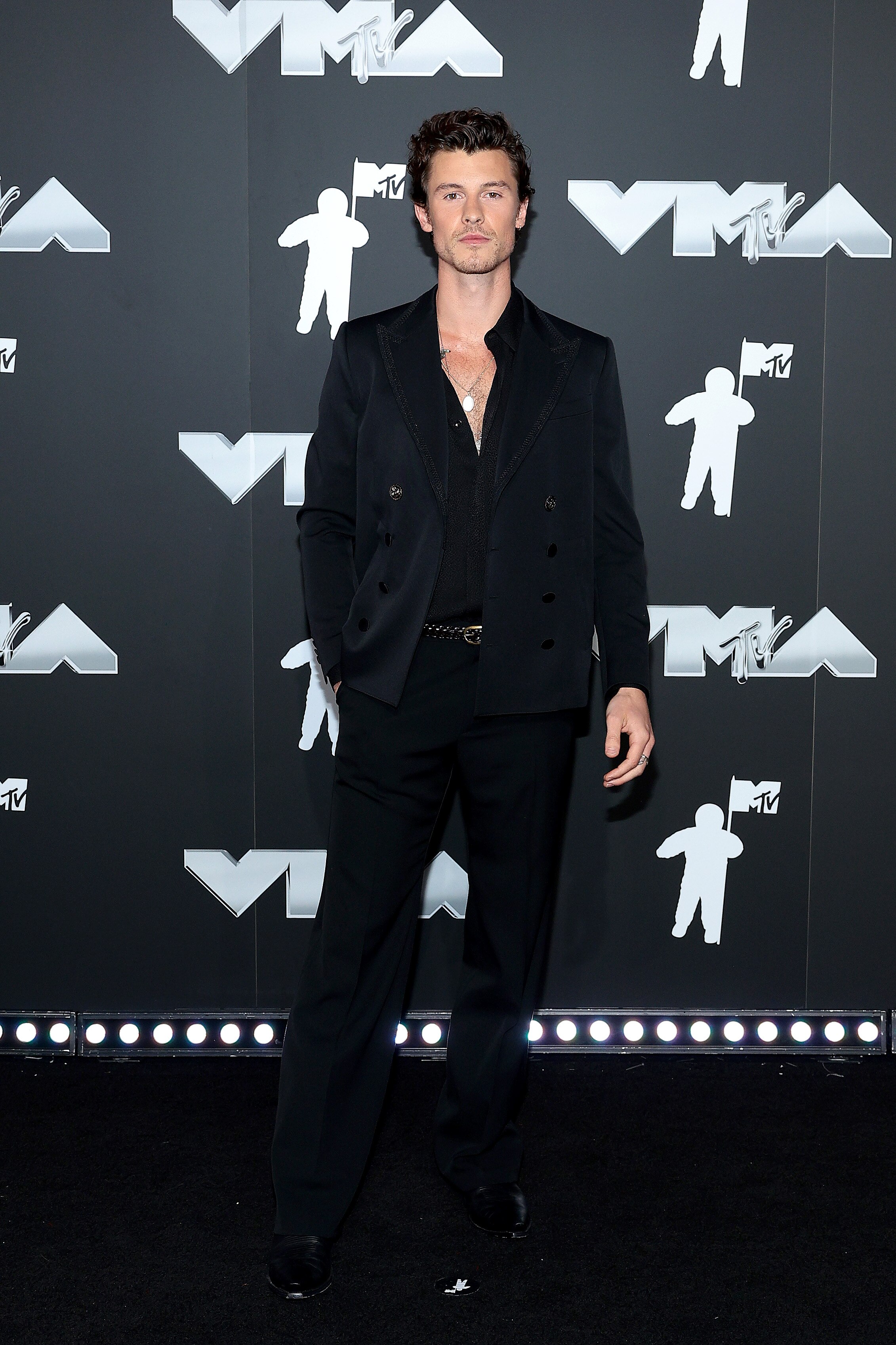 Shawn Mendes wearing a black suit on the VMAs red carpet