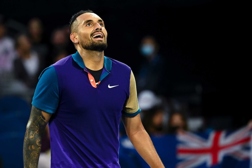 Nick Kyrgios looks skywards and smiles