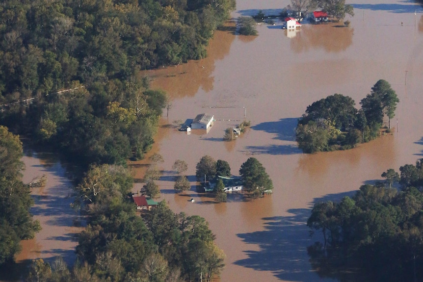An aerial photo of a small town, where almost every building is underwater.