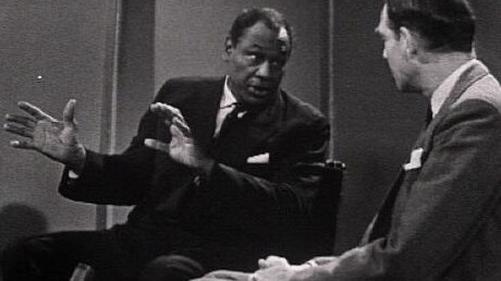 Paul Robeson sits in TV interview