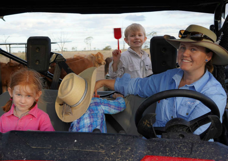 Genevieve Hawkins and her children sitting in a ute.