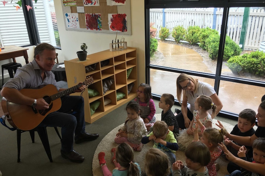 Premier Will Hodgman plays guitar for Kingston kids