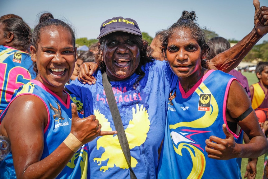 Grandmother Lilly Rogers and her two granchildren after the first women's West Kimberley Football League grand final
