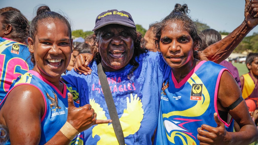 Grandmother Lilly Rogers and her two granchildren after the first women's West Kimberley Football League grand final