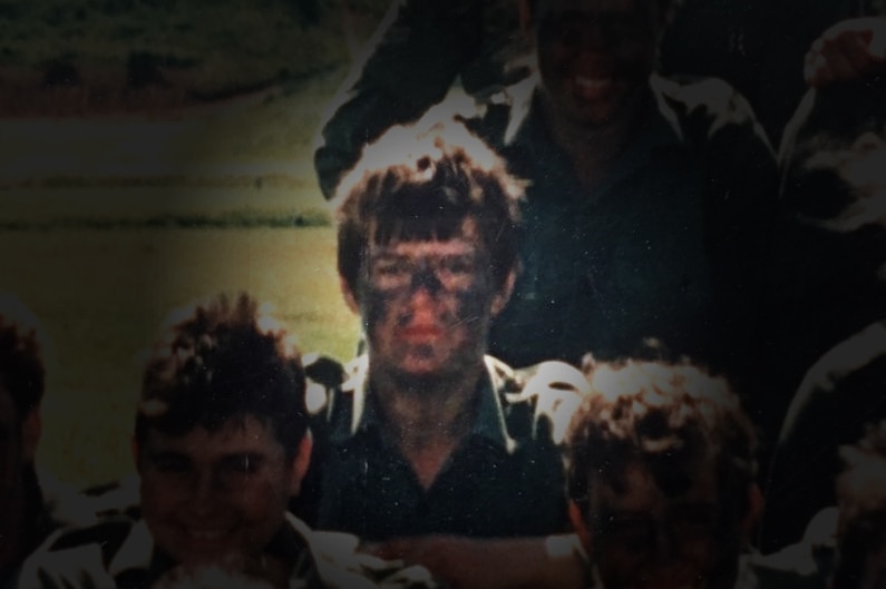 A woman with a muddy face among a group of soldiers, whose faces are shaded.