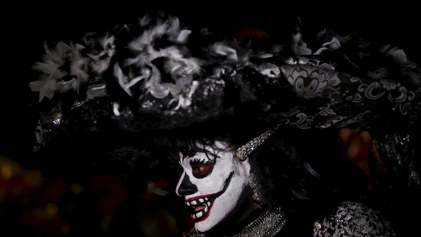 A man dressed up as a Catrina for Day of the Dead