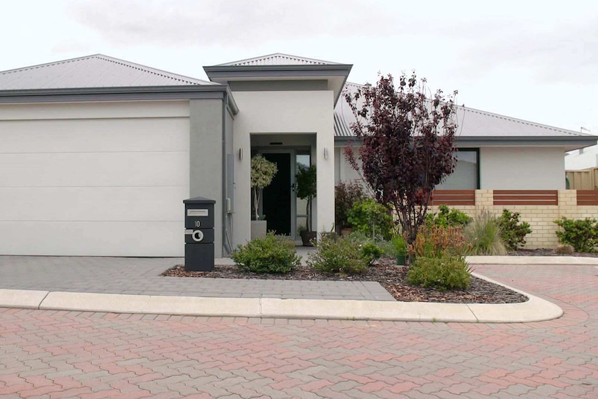 An exterior shot of a grey single-storey home.