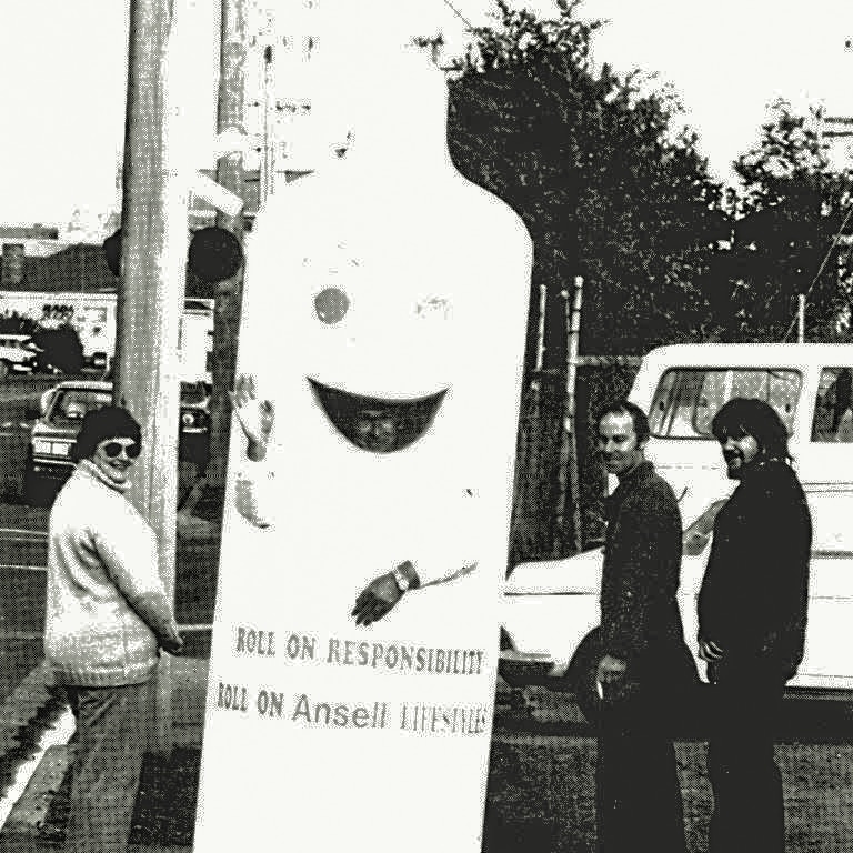 Black and white picture of a man inside a giant condom