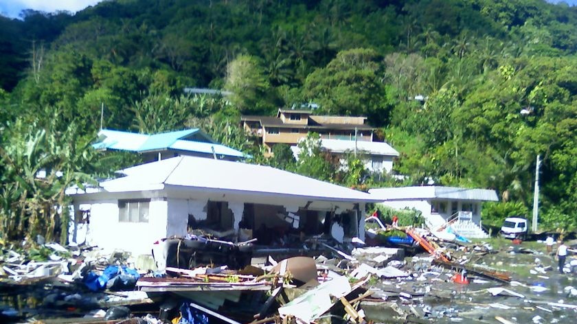 A man surveys the damage in Pago Pago on the island of American Samoa