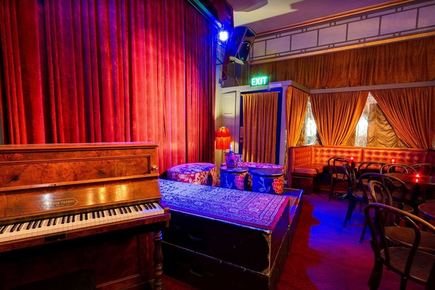 Interior of a lounge venue with red curtains