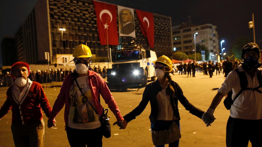 Demonstrators form a human chain in Taksim Square.
