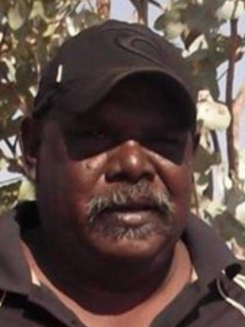an aboriginal man with a moustache, wearing a cap