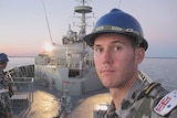 Scott Perrin selfie standing on the deck of a naval vessel at sea