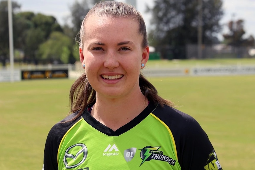 WBBL Sydney Thunder's Rachel Trenaman smiling with the cricket oval behind her