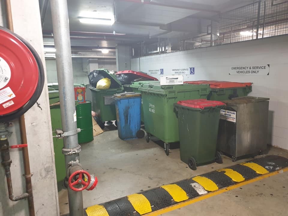 Disabled parking bays blocked by dumpster bins in Campbelltown.