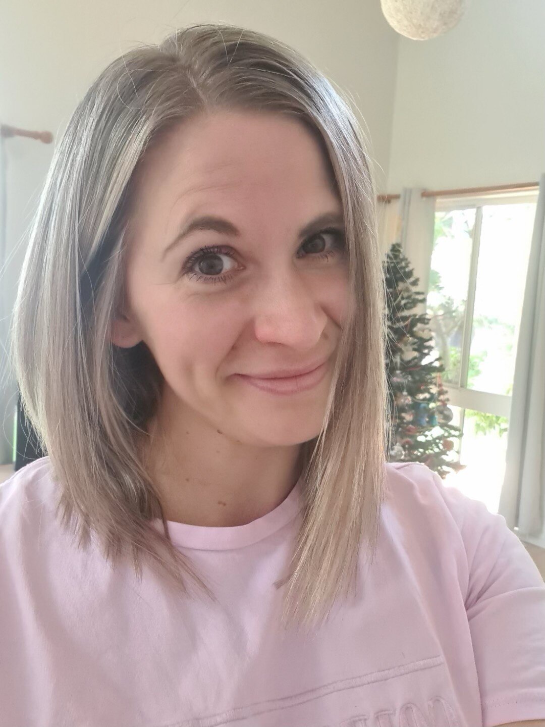 A woman with blonde hair smiles.