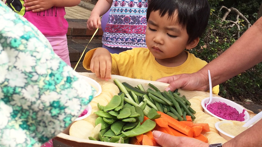 Young children eating healthy food in Canberra.