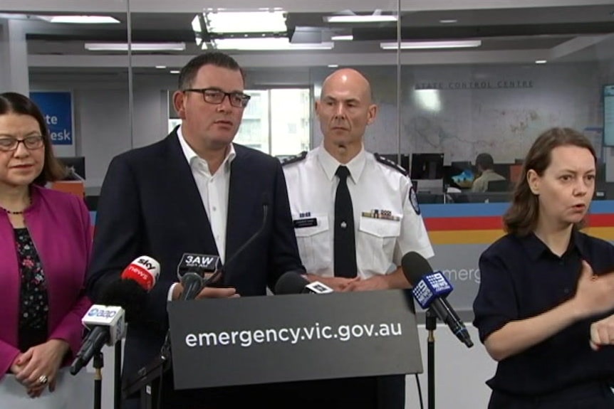 Health Minister Jenny Mikakos, Premier Daniel Andrews and Emergency Management Commissioner Andrew Crisp stand at a lectern.