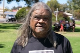 a man with long hair smiling