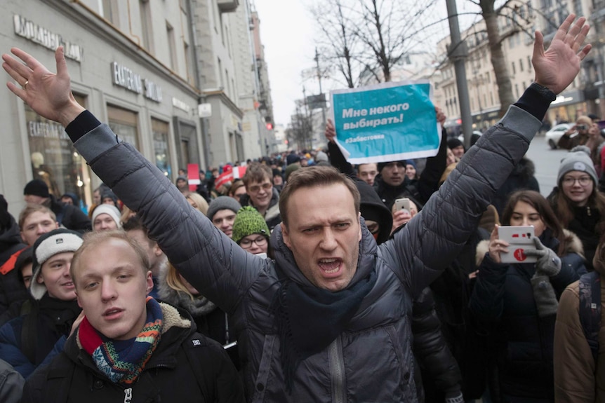 Russian opposition leader Alexei Navalny, centre, is surrounded by protesters.