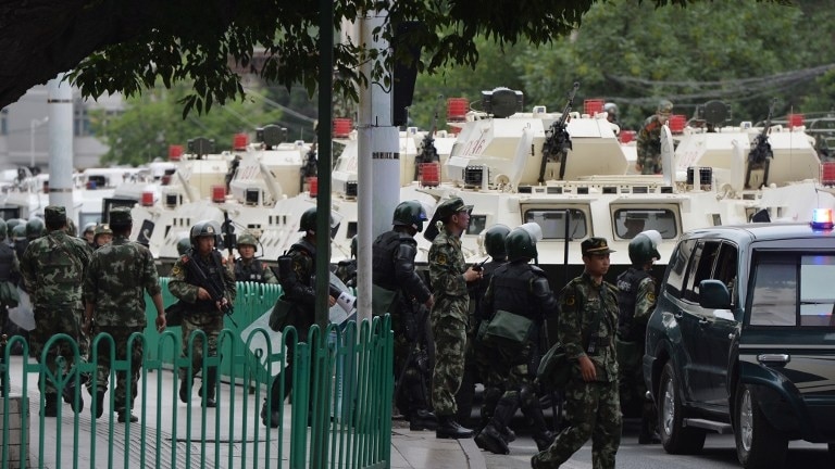 Chinese paramilitary police prepare to ride armoured vehicles through Urumqi, Xinjiang, China.