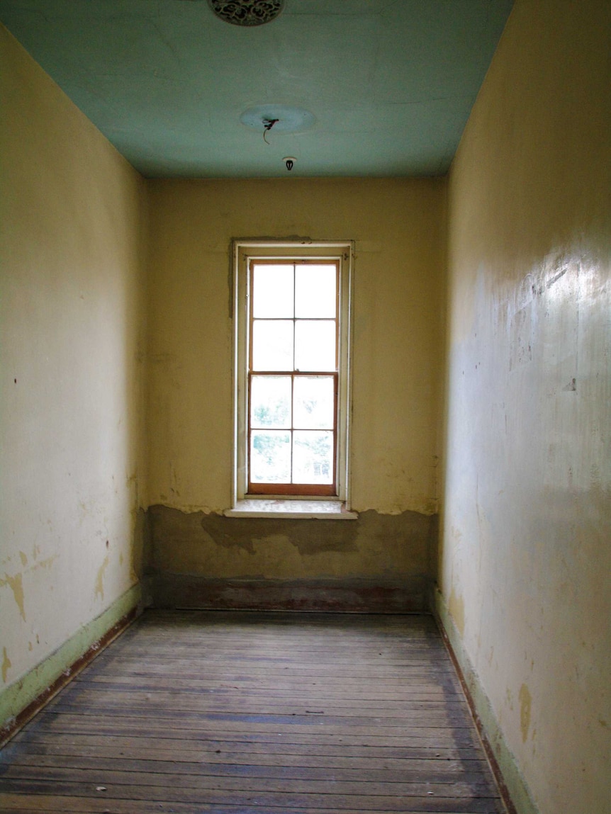 A small room with chipped paint