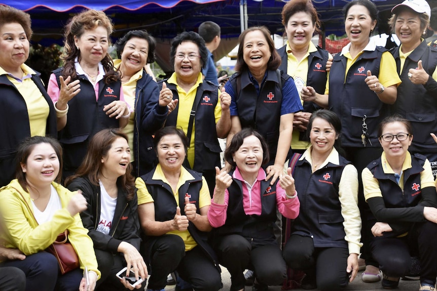 Thai volunteers celebrate the good news that the boys were rescued