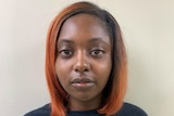 Headshot of Marshae Jones, a young African American woman with orange hair and wearing a black T-shirt.