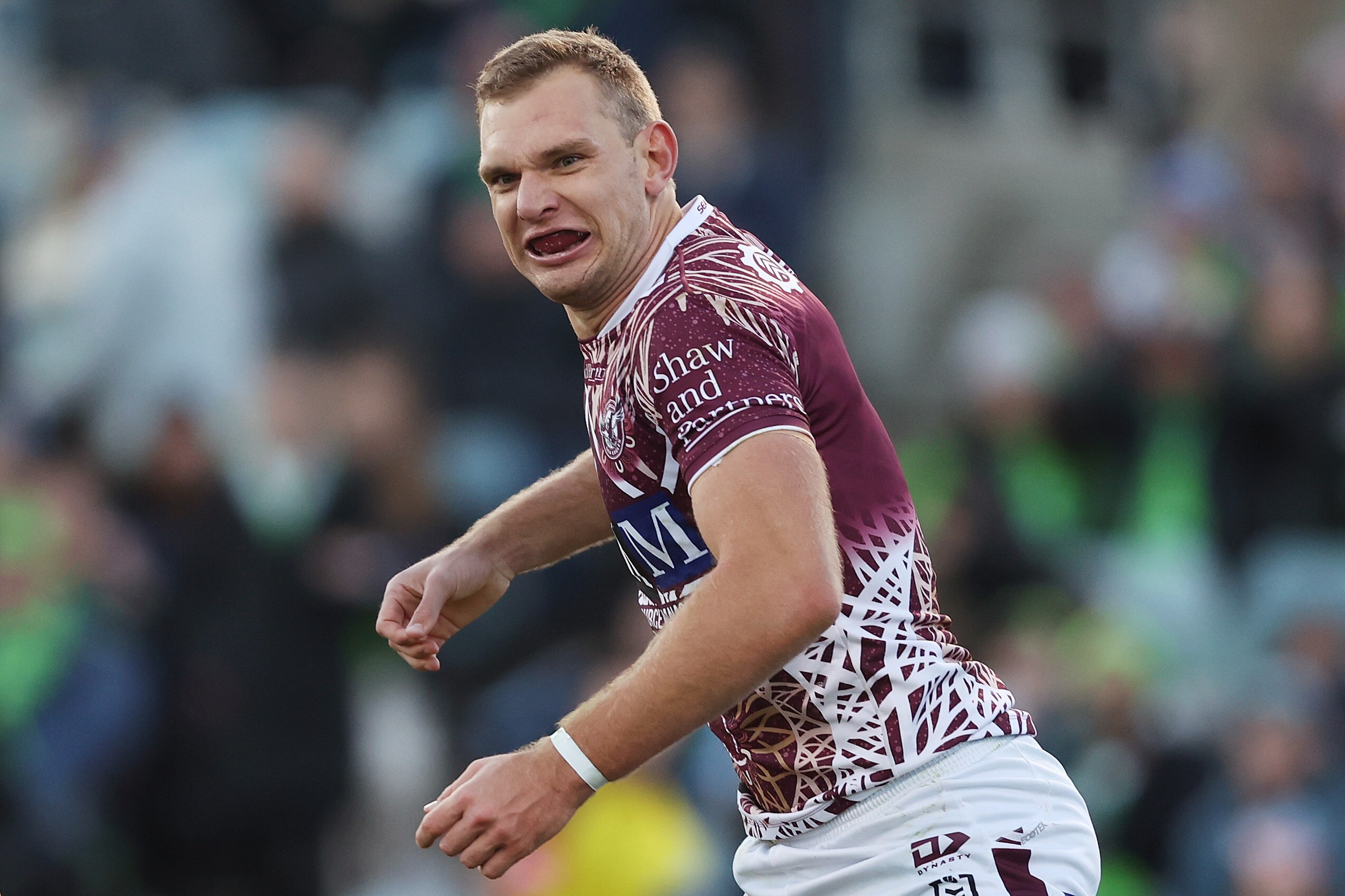 A Manly NRL player celebrates a try against Canberra.
