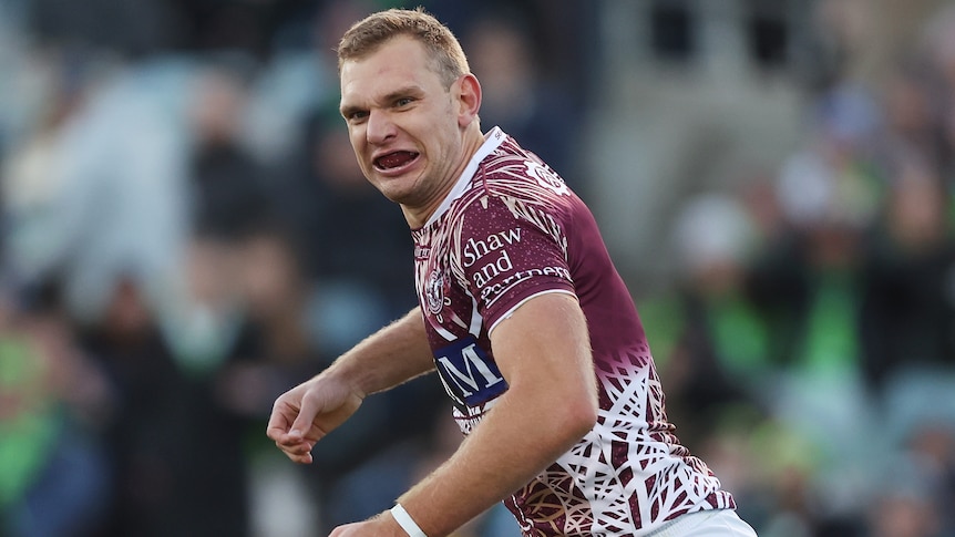 A Manly NRL player celebrates a try against Canberra.