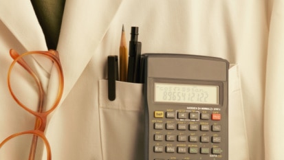 Lab coat with pens, glasses and calculator (Stockbyte: Thinkstock)