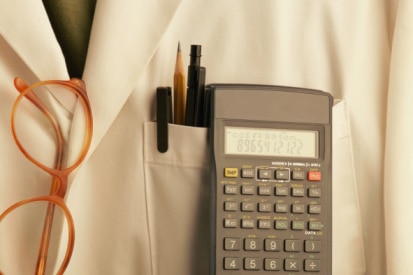 Lab coat with pens, glasses and calculator (Stockbyte: Thinkstock)