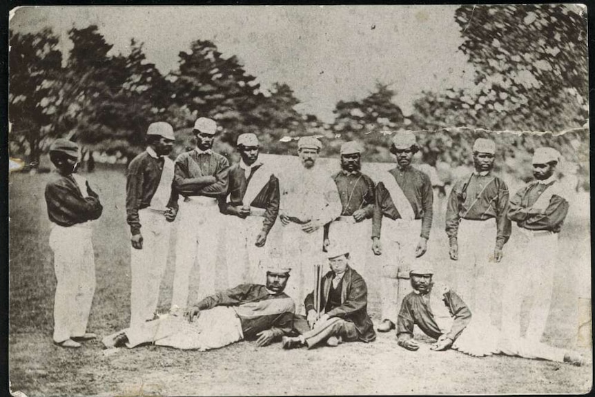 A group photo taken in England of the First Xl Aboriginal cricket team dressed in their uniforms.