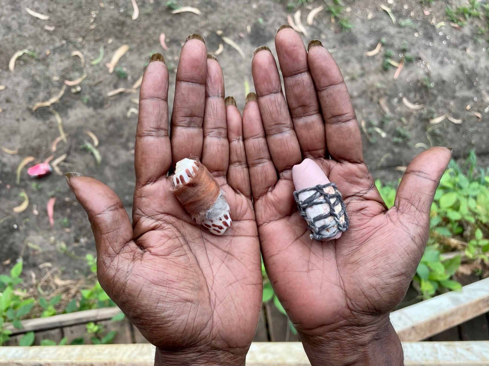 A woman's hands holding two shells, seen from above
