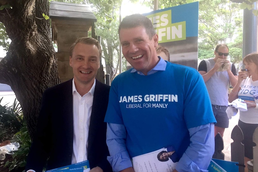 Griffin and Baird smiling at the voting booths.