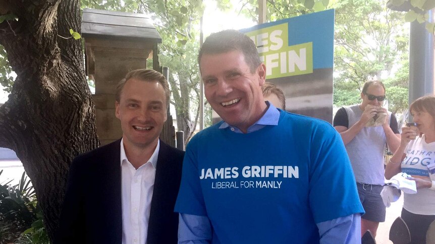 Griffin and Baird smiling at the voting booths.