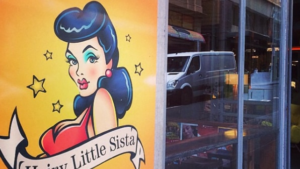 Hairy Little Sista bar's sign and front windows.