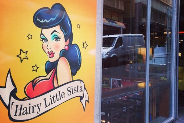 Hairy Little Sista bar's sign and front windows.