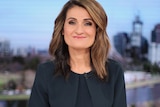 Patricia Karvelas smiles while sitting at the ABC News desk