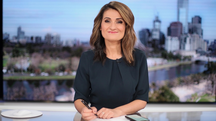 Patricia Karvelas smiles while sitting at the ABC News desk