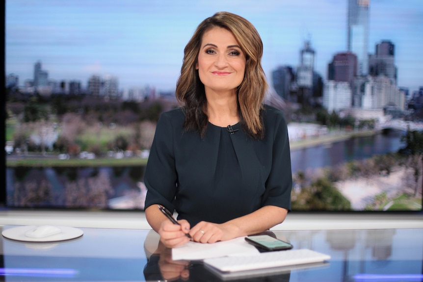 Patricia Karvelas smiles while sitting at the ABC News desk