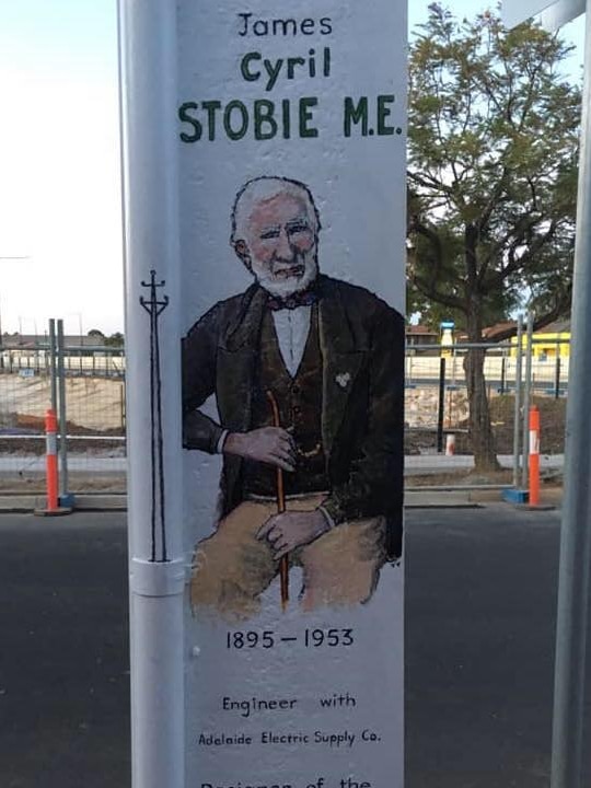 A painting of James Cyril Stobie, the inventor or the Stobie pole, on a Stobie pole