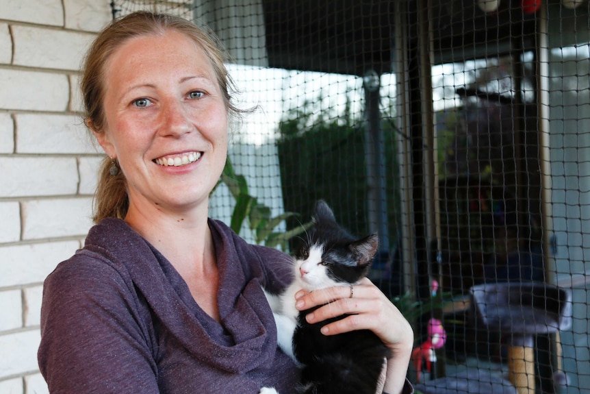 Canberran Anna Reimondos holds a rescued kitten outside a south Canberra home. November 2017.