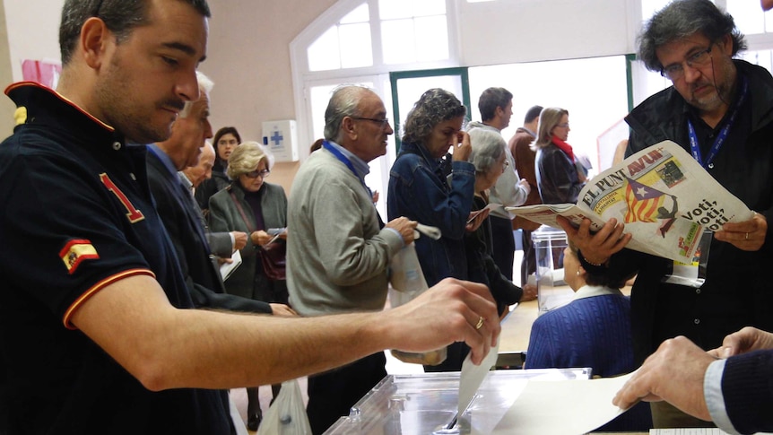 A man casts his vote during elections in Catalonia, Spain